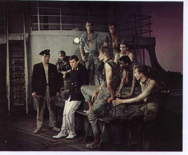 a rare production photograph! Alan is front row, second from right, with foot on bench